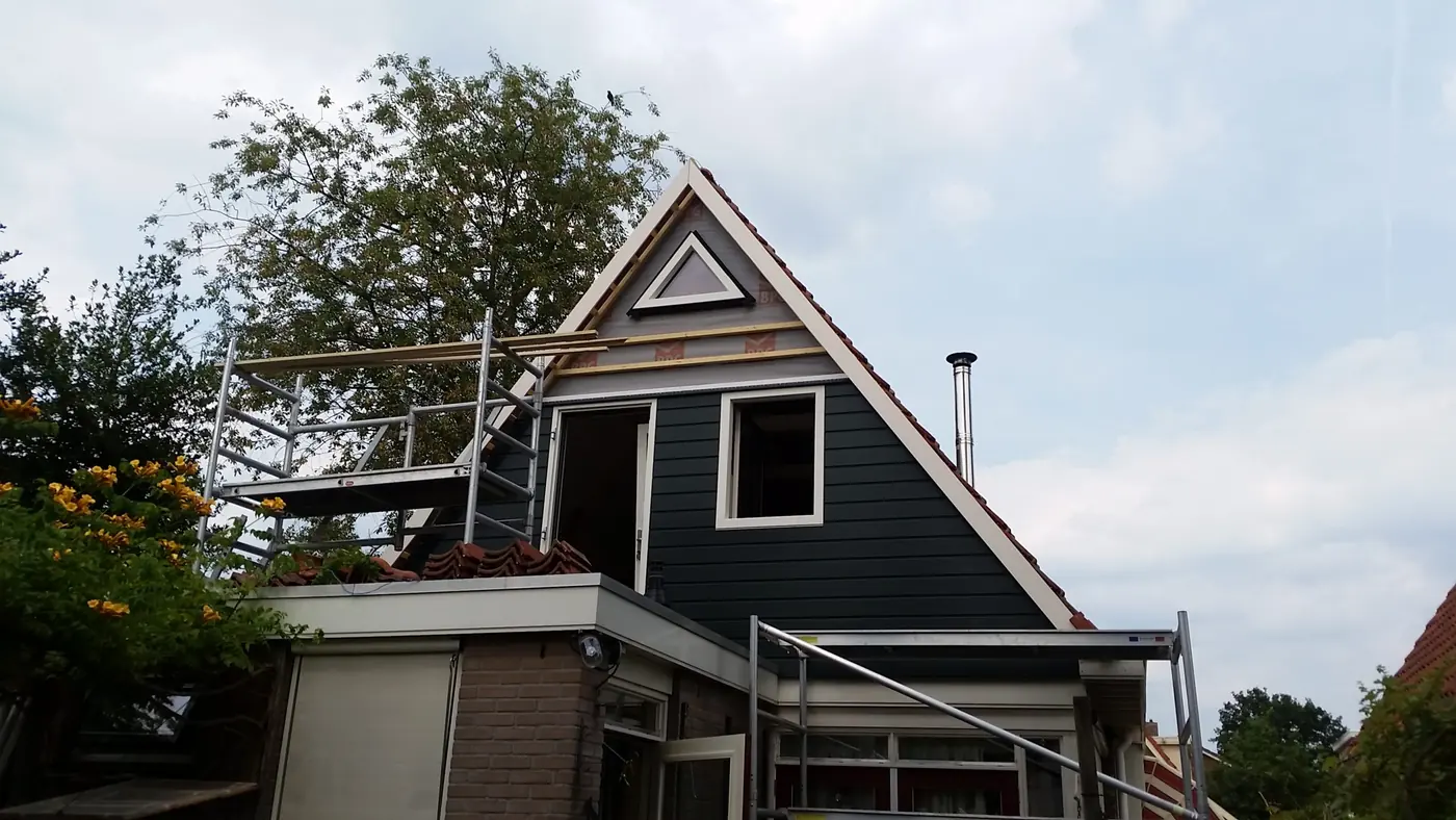 Opgeleverde uitbreiding van de eerste verdieping in Heerenveen, met donkergroene gevelbekleding en een rode deur, foto 10